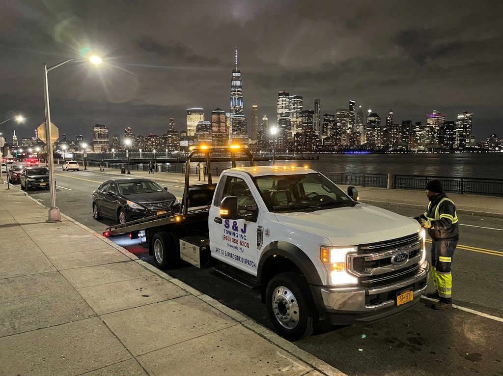 S & J Towing securing a passenger car for transport in New Jersey